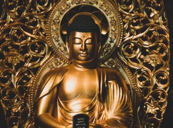 gold and black hindu deity figurine