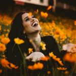 woman laughing on flower field